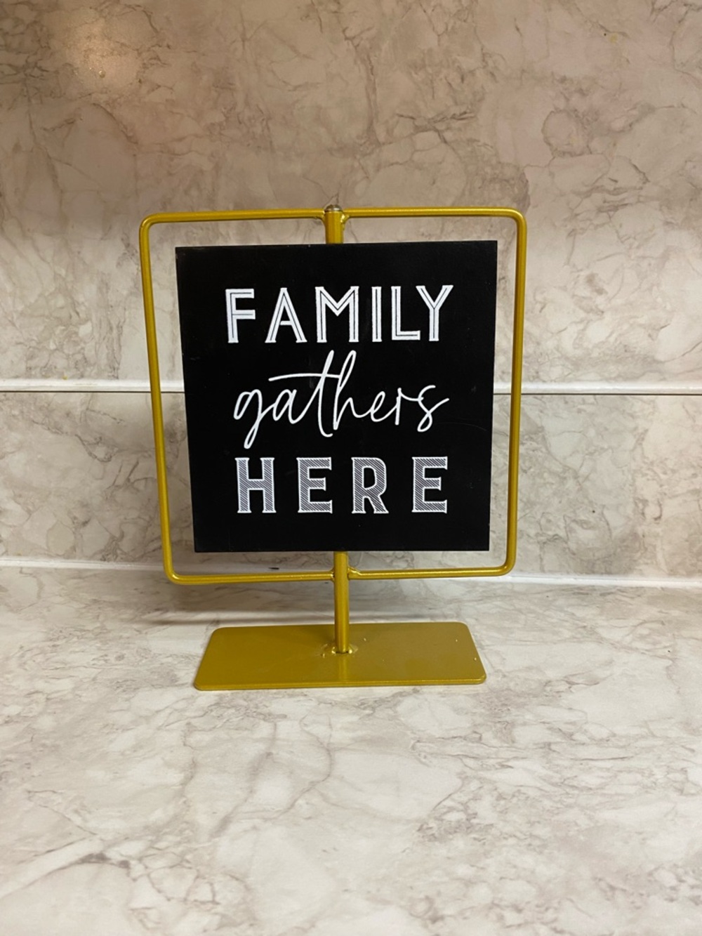 Family Gathers Here Black Sign on Gold Stand